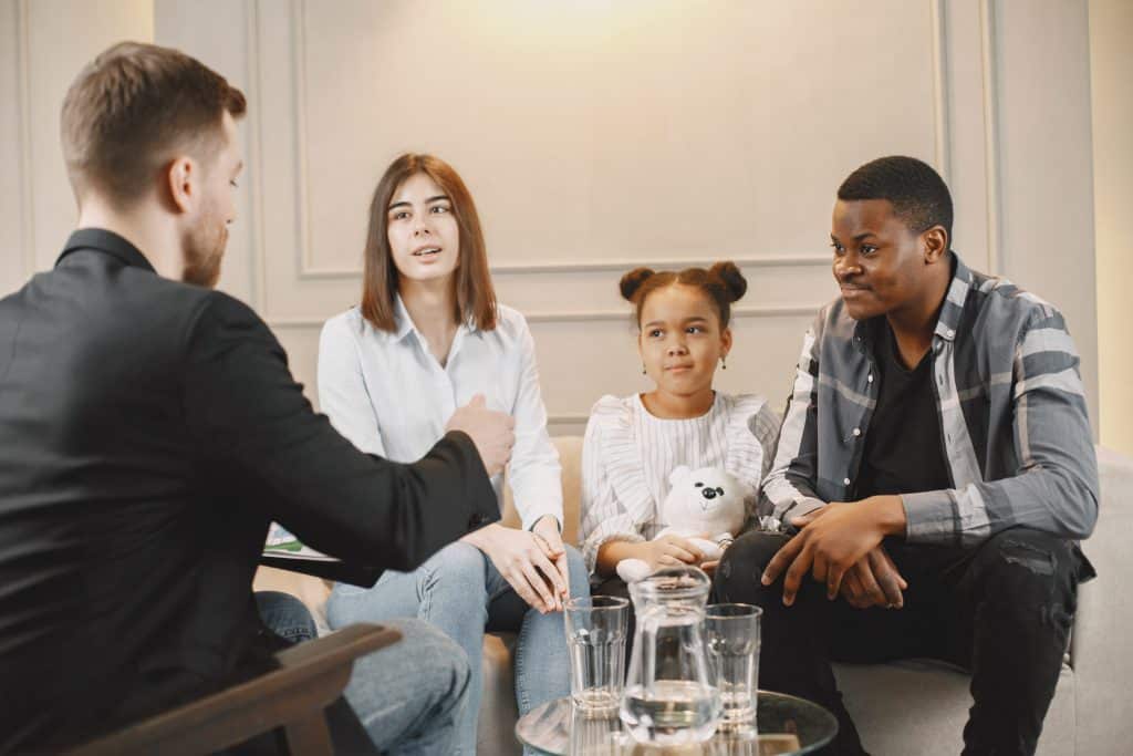 Family with daughter having a session with a lawyer